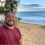 a man taking a selfie on a beach